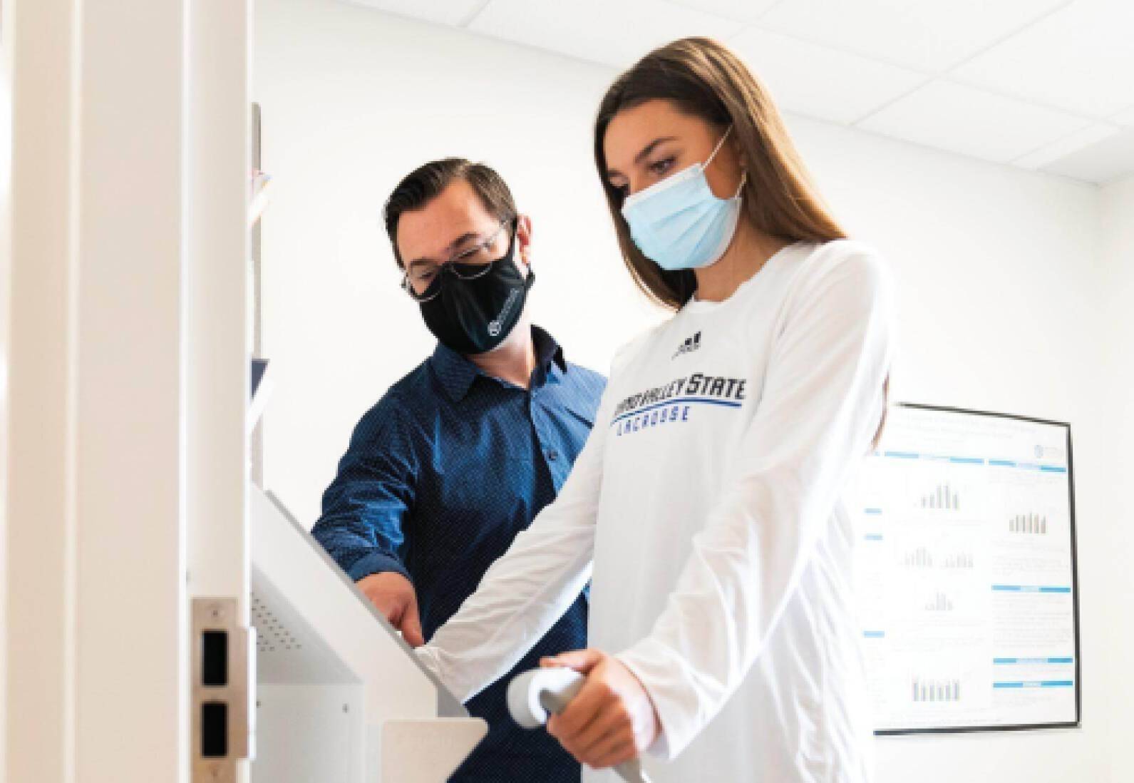 Professor working with student during exercise testing